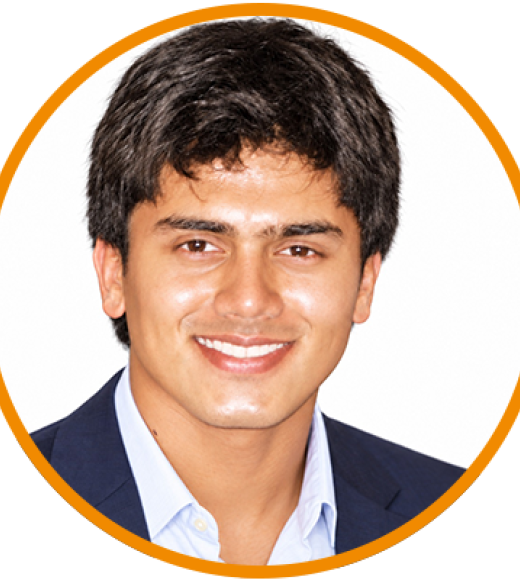 Smiling young man headshot in navy blazer, circular crop with orange border