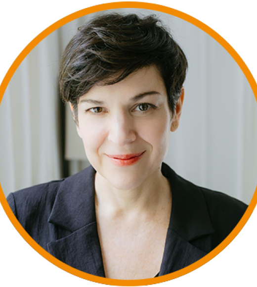 Smiling woman with short dark hair in dark blazer, headshot photograph with orange circular frame
